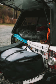 Inflatable Kayak deflated and compacted inside trunk of car