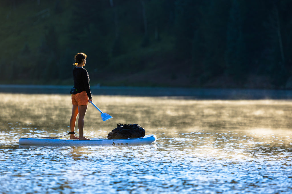 Woman using a Chasm-Lite Inflatable SUP on the water