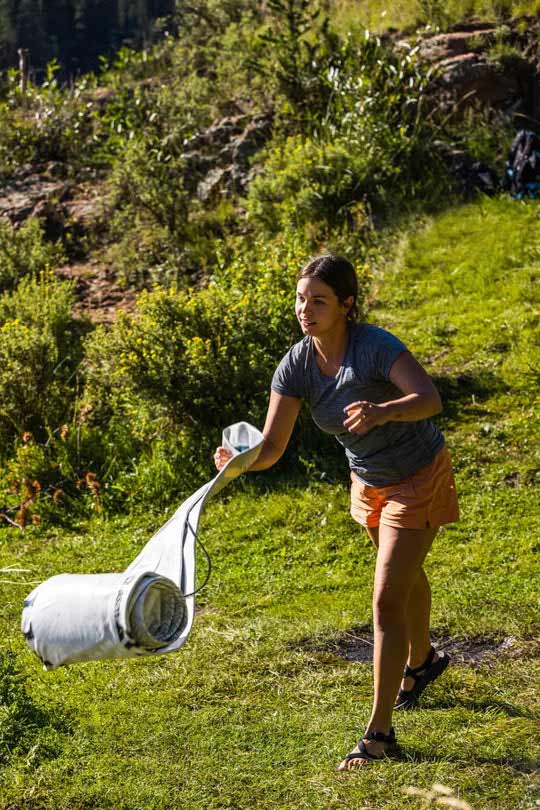 Woman rolling out a Chasm-Lite Inflatable SUP